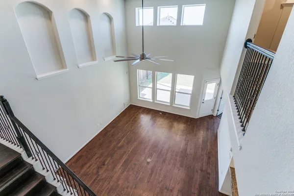 a view of entryway and hall with wooden floor