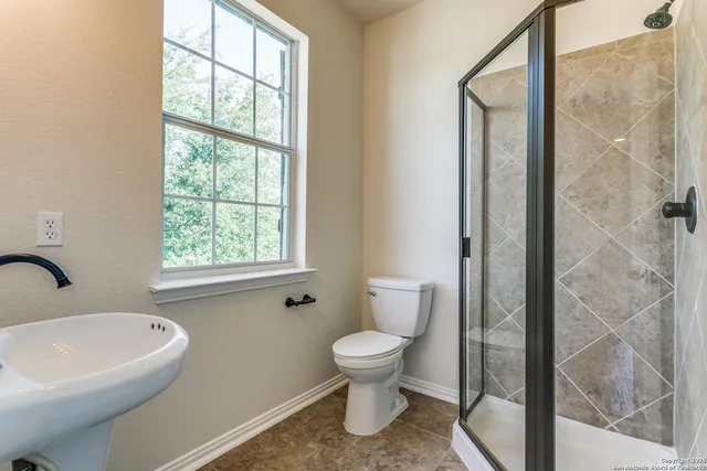 a white toilet sitting next to a bathroom sink