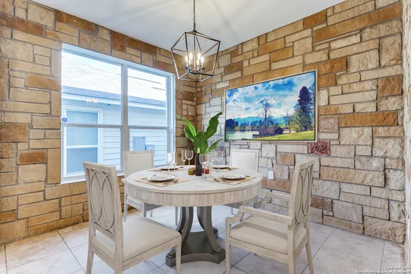 a view of a dining room with furniture and window