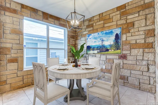 a view of a dining room with furniture and window