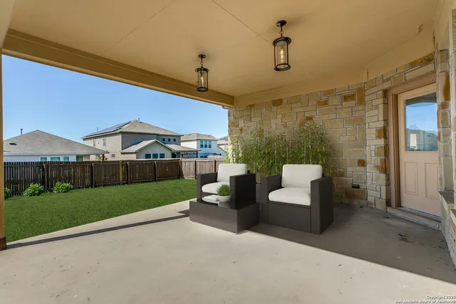 a view of a patio in the backyard