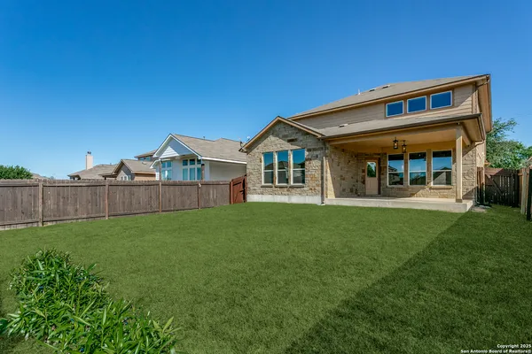a view of a house with backyard and porch