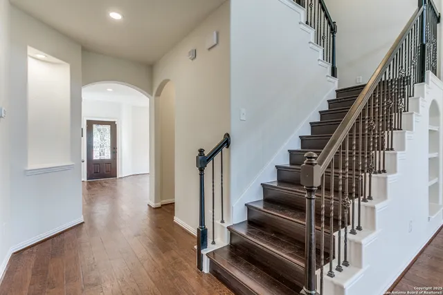 a view of entryway and hall with wooden floor