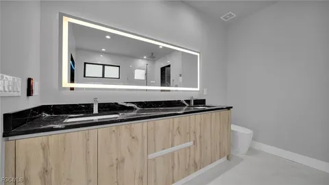 a view of a hallway with wooden floor and windows