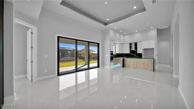 a view of large kitchen with a sink and refrigerator