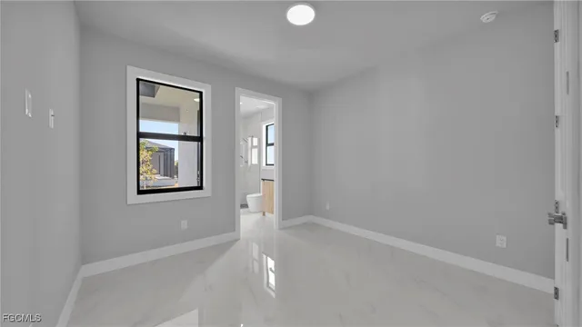 a bathroom with a granite countertop sink a toilet a mirror and shower