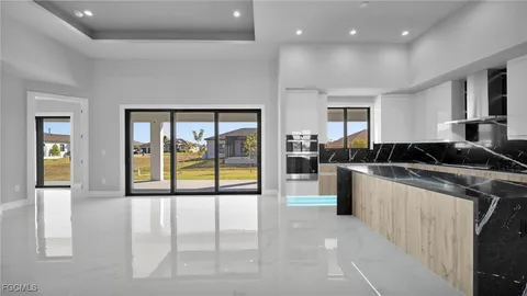 a kitchen with a large window and a sink