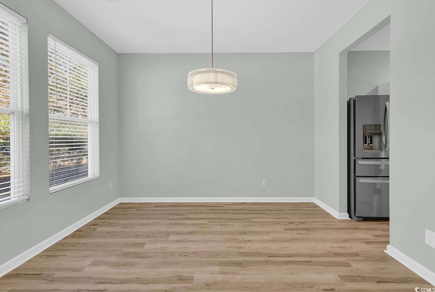 308 Kiskadee Loop, Unit E Conway, SC 29526 - Photo 2 of 36 Unfurnished dining area featuring light wood-type flooring