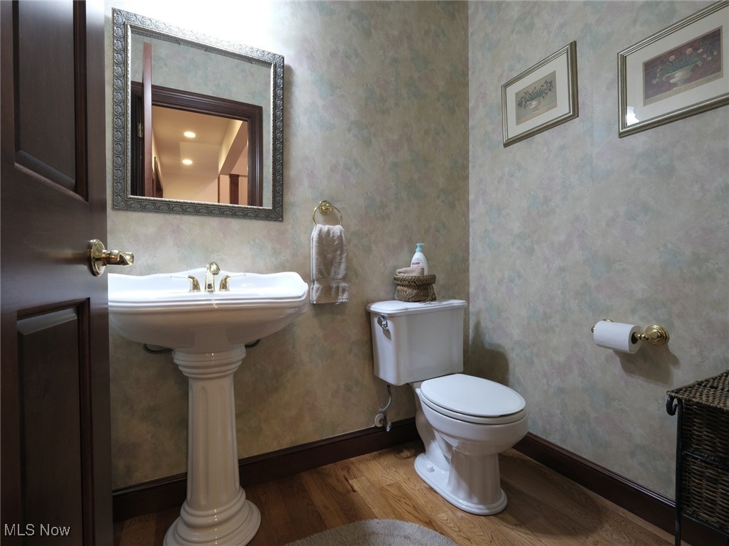 9659 Yoder Road Southwest Sugarcreek, OH 44681 - Photo 7 of 39 Bathroom featuring hardwood / wood-style flooring and toilet