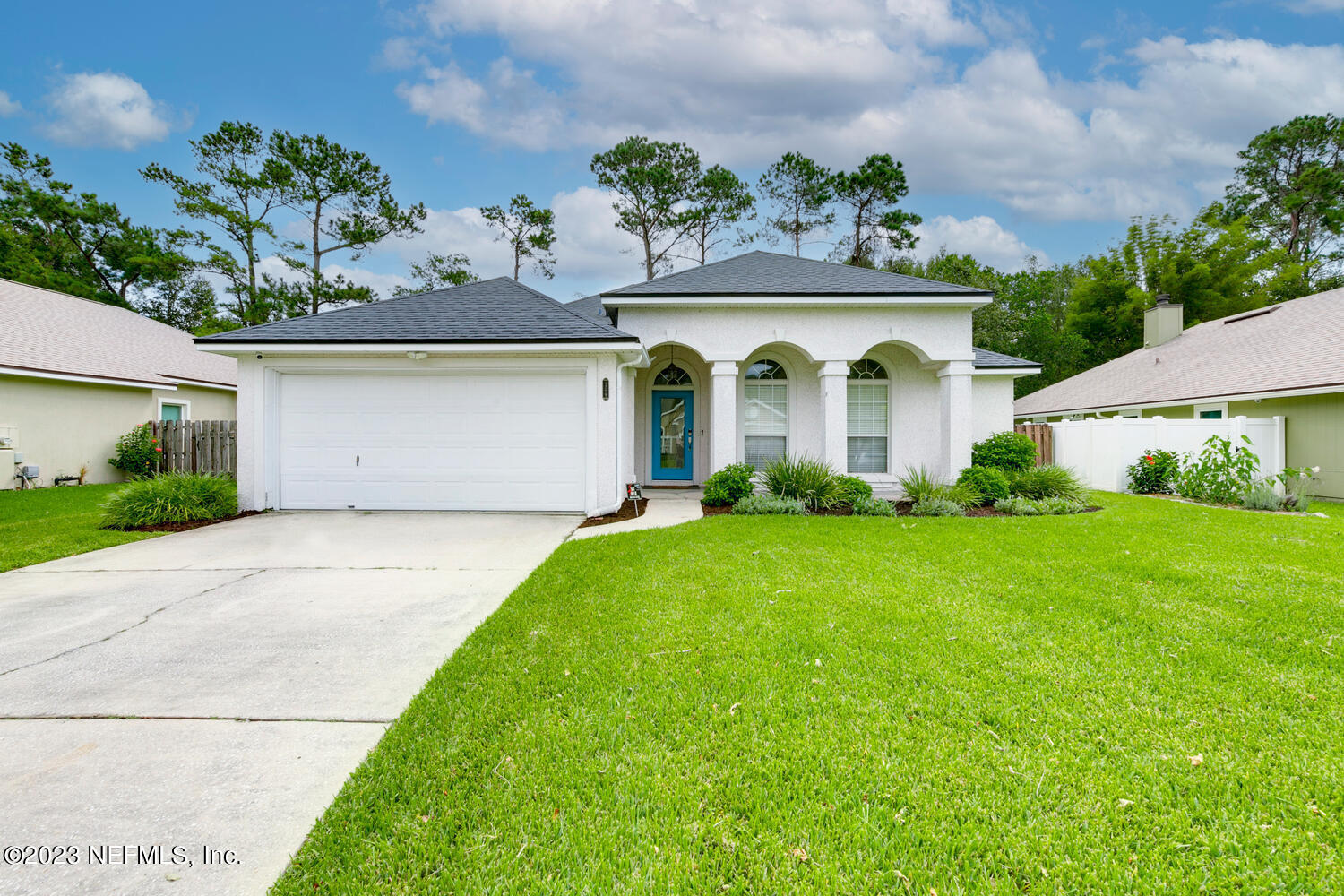 1779 Tall Tree Drive East Jacksonville, FL 32246 - Photo 1 of 26 a front view of a house with garden