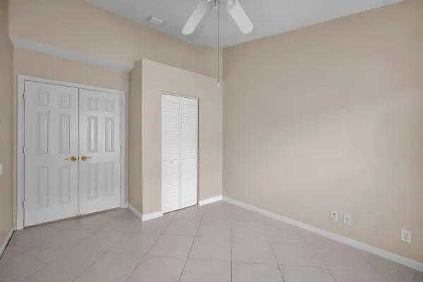 an empty room with a chandelier fan