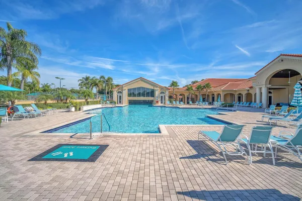 a view of swimming pool with outdoor seating and city view