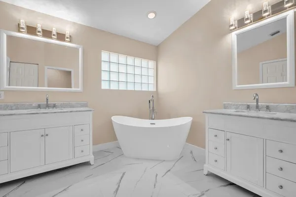 a bathroom with a granite countertop sink double and mirror