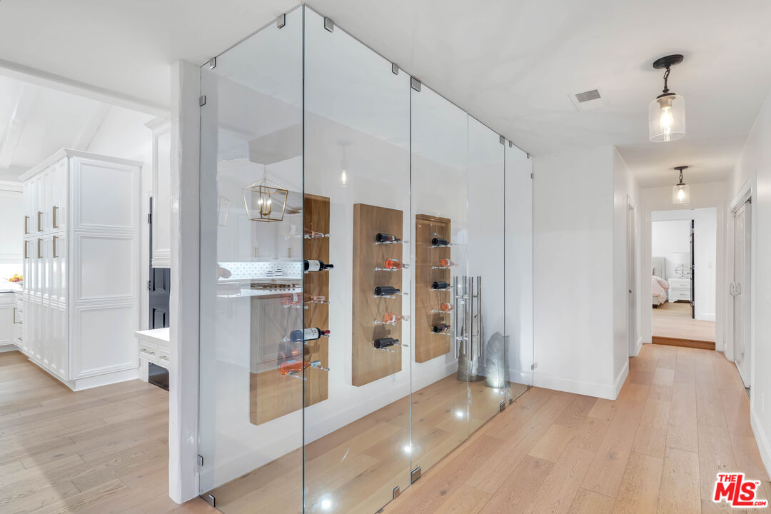 5488 Round Meadow Road Hidden Hills, CA 91302 - Photo 15 of 35 a view of a hallway with wooden shelves