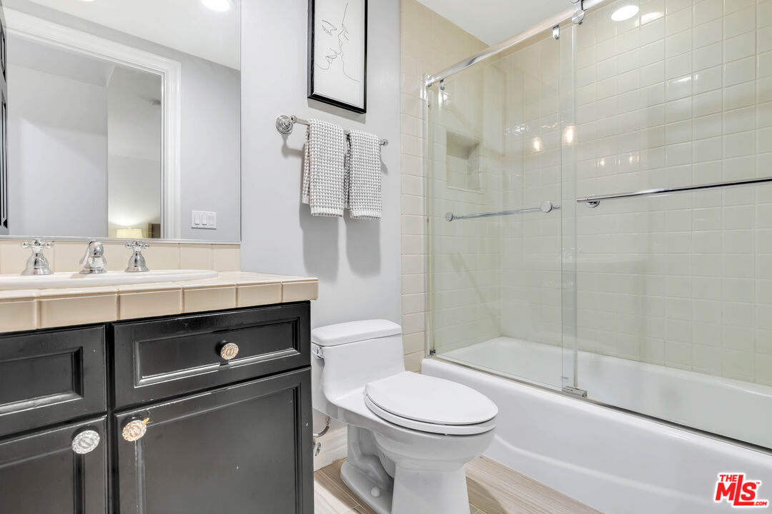 5488 Round Meadow Road Hidden Hills, CA 91302 - Photo 28 of 35 a bathroom with a sink a toilet and shower