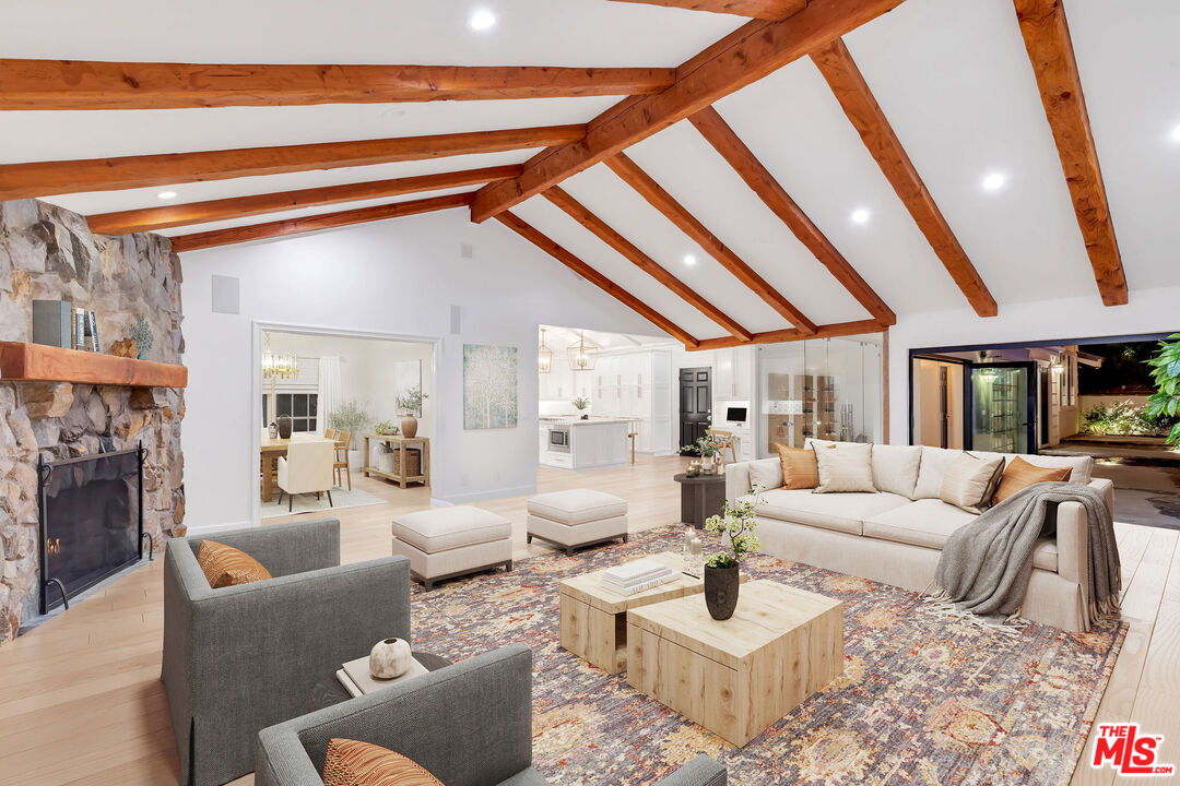 5488 Round Meadow Road Hidden Hills, CA 91302 - Photo 6 of 35 a living room with furniture and a fireplace