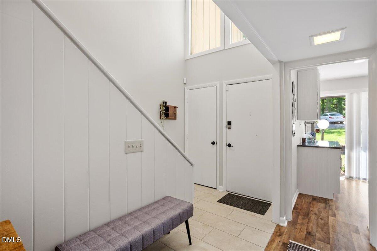 5045 Tall Pines Court Raleigh, NC 27609 - Photo 5 of 37 a view of entryway with wooden floor and stairs