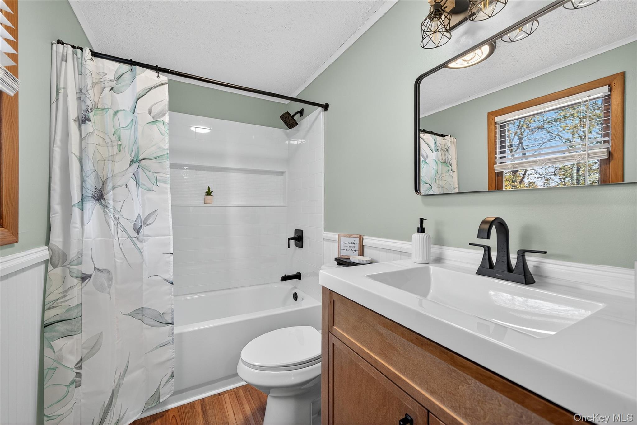 7 Colleen Lane Wallkill, NY 12589 - Photo 24 of 39 Bathroom featuring a textured ceiling, shower / tub combo, vanity, dark wood-style flooring, and ornamental molding