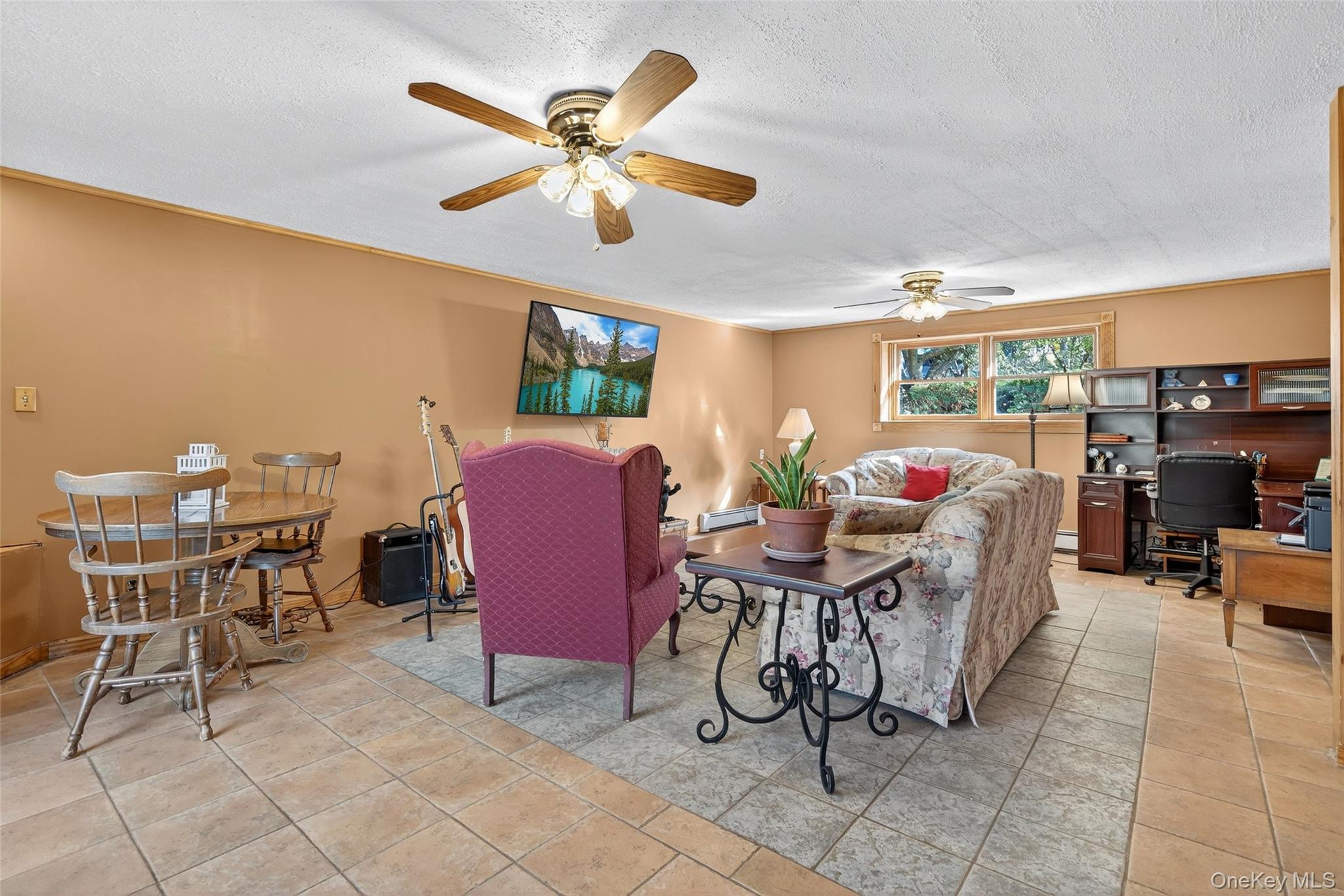 7 Colleen Lane Wallkill, NY 12589 - Photo 28 of 39 Living area featuring a textured ceiling, a desk, light tile patterned floors, and ceiling fan