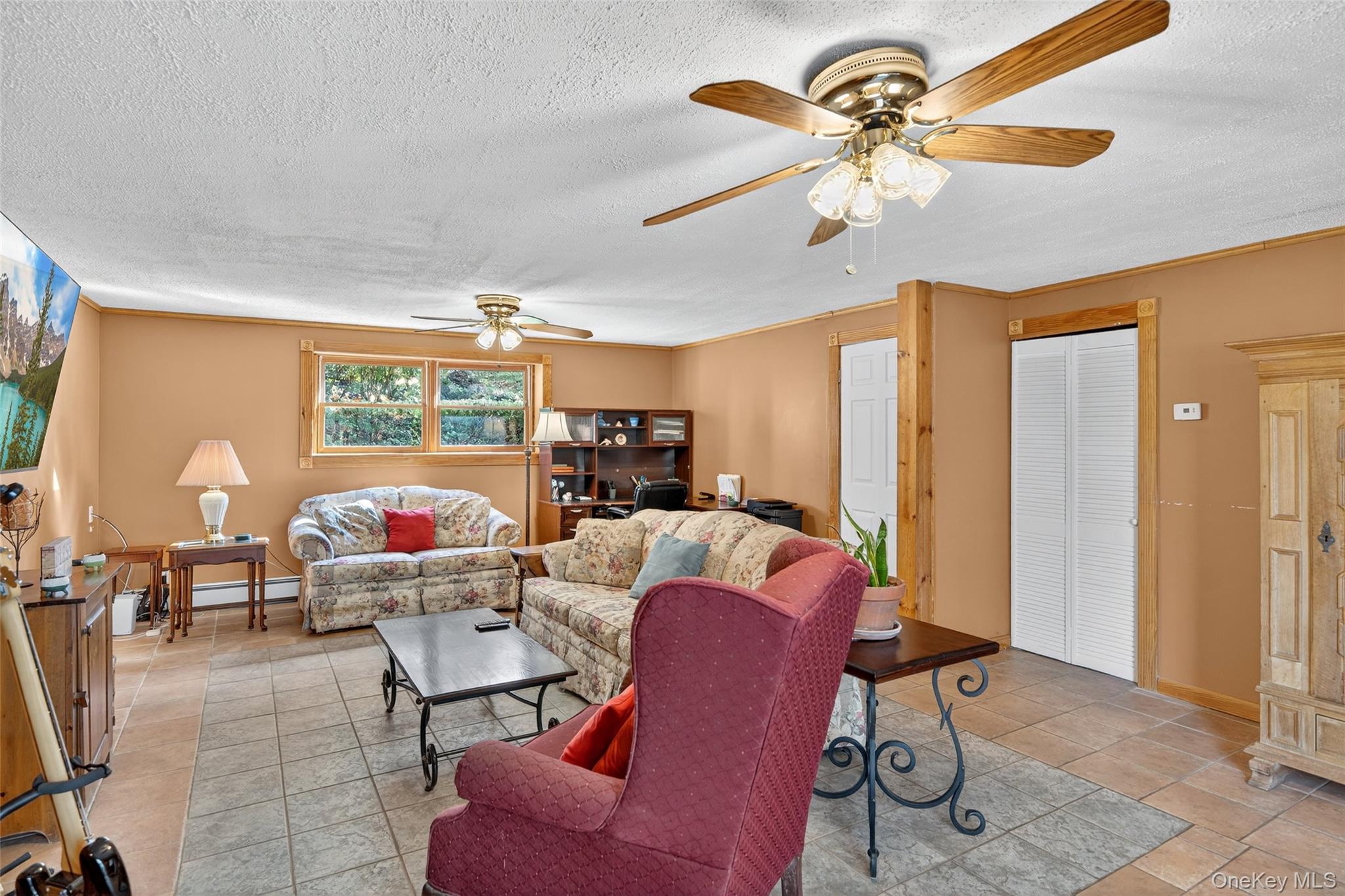 7 Colleen Lane Wallkill, NY 12589 - Photo 29 of 39 Living room featuring a textured ceiling, ornamental molding, and ceiling fan