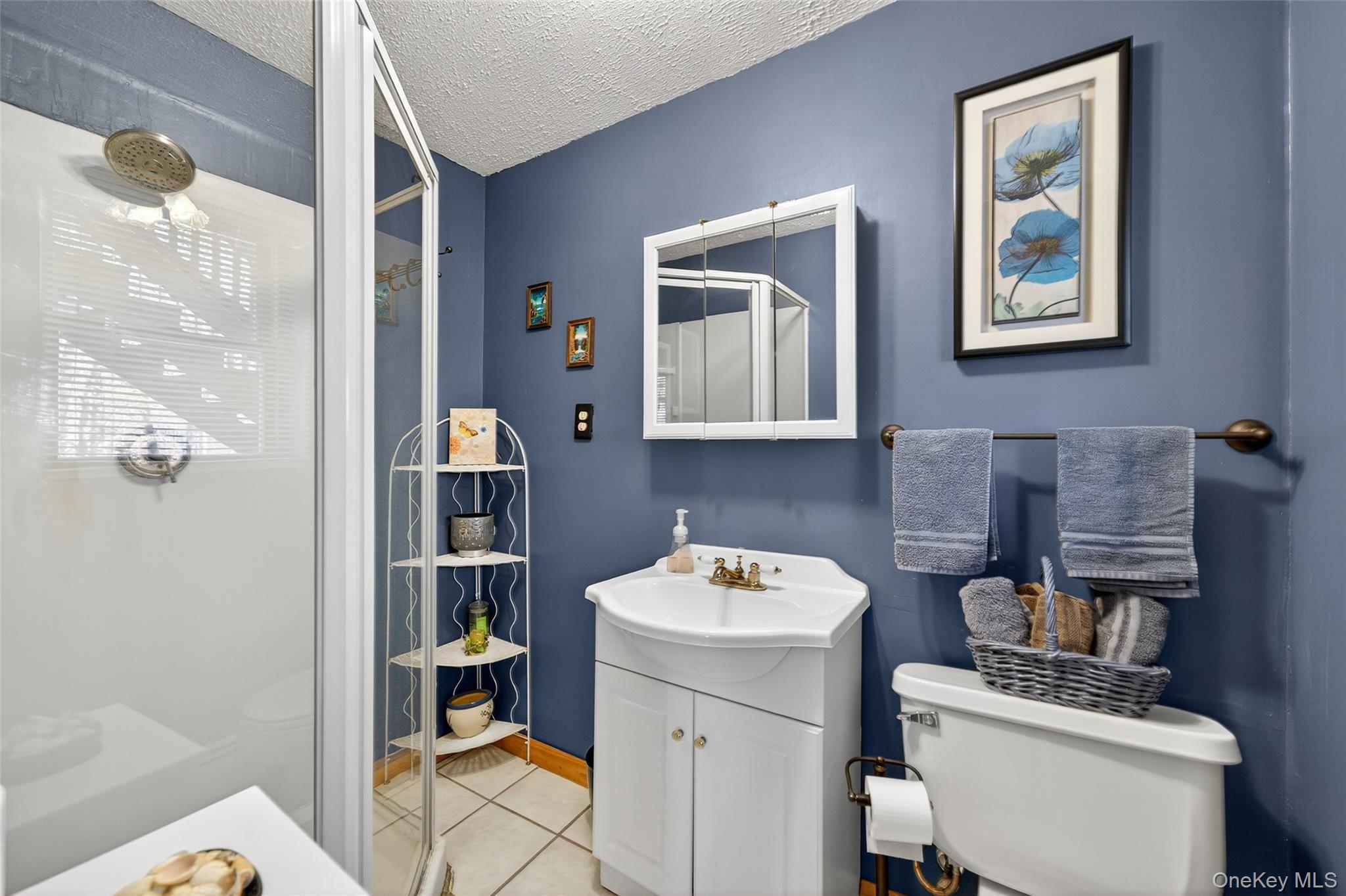 7 Colleen Lane Wallkill, NY 12589 - Photo 30 of 39 Full bathroom with vanity, light tile patterned flooring, a textured ceiling, and a stall shower