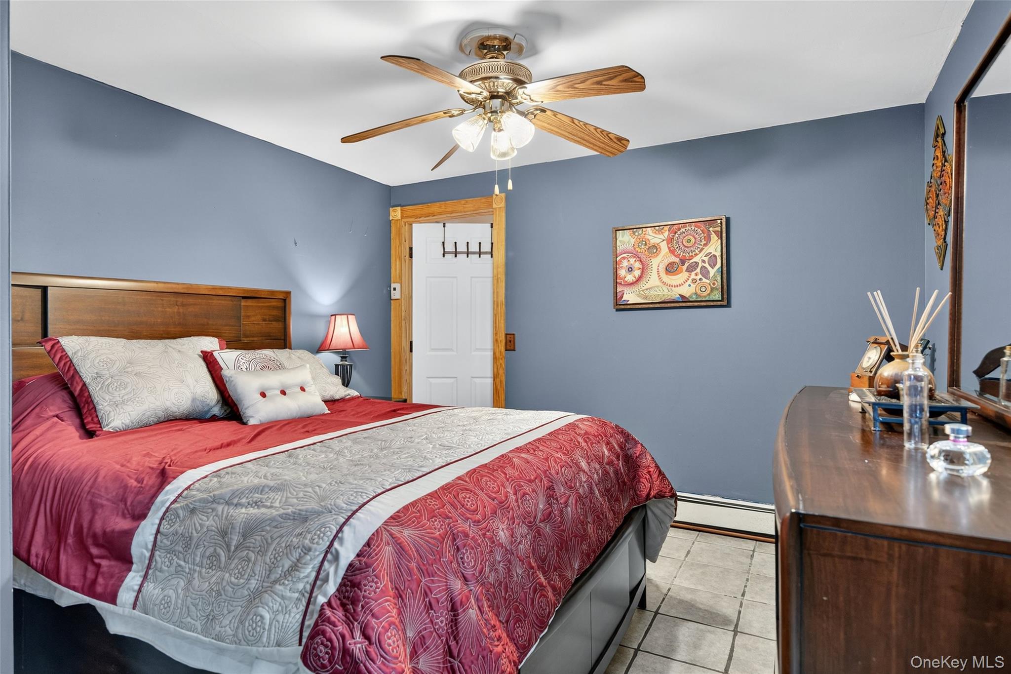 7 Colleen Lane Wallkill, NY 12589 - Photo 33 of 39 Tiled bedroom featuring a baseboard radiator and a ceiling fan