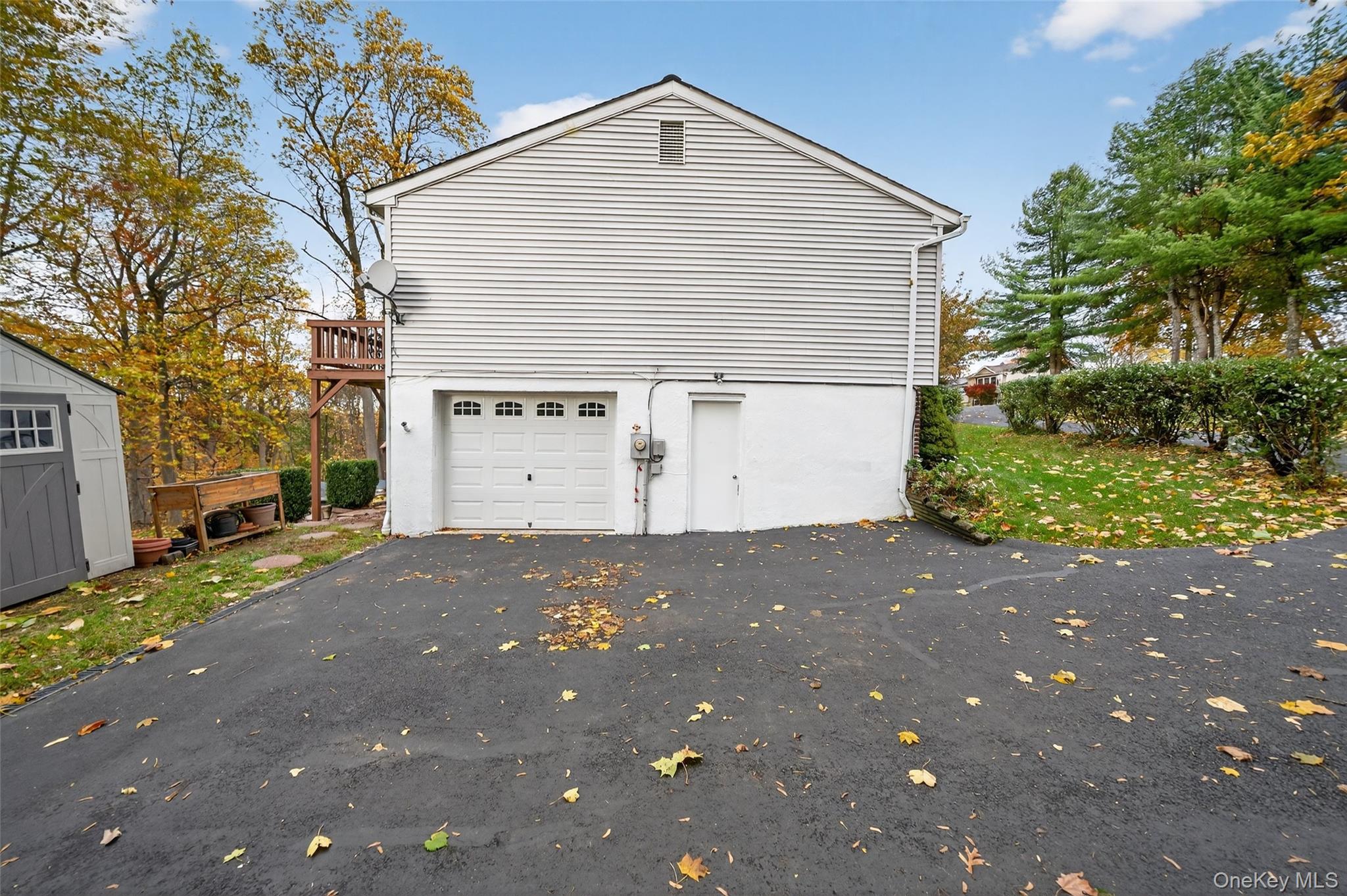 7 Colleen Lane Wallkill, NY 12589 - Photo 35 of 39 Garage featuring driveway and a storage unit