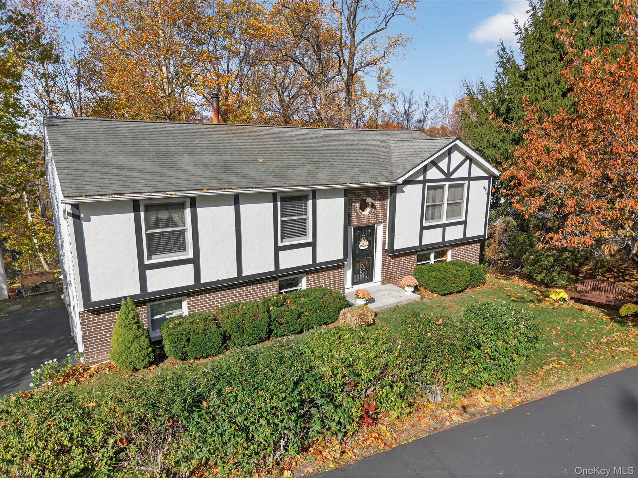 7 Colleen Lane Wallkill, NY 12589 - Photo 5 of 39 View of front of house featuring brick siding, a shingled roof, and view of scattered trees