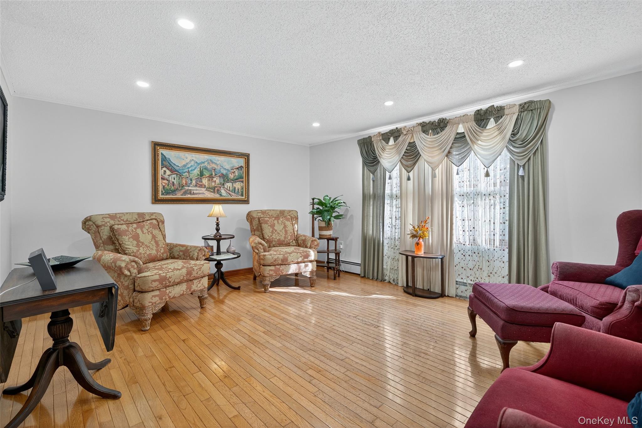 7 Colleen Lane Wallkill, NY 12589 - Photo 8 of 39 Sitting room with light wood-type flooring, recessed lighting, a textured ceiling, and a baseboard heating unit