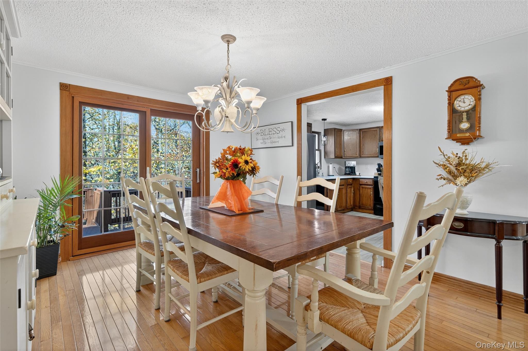 7 Colleen Lane Wallkill, NY 12589 - Photo 10 of 39 Dining area with light wood-style floors, a textured ceiling, ornamental molding, and a chandelier