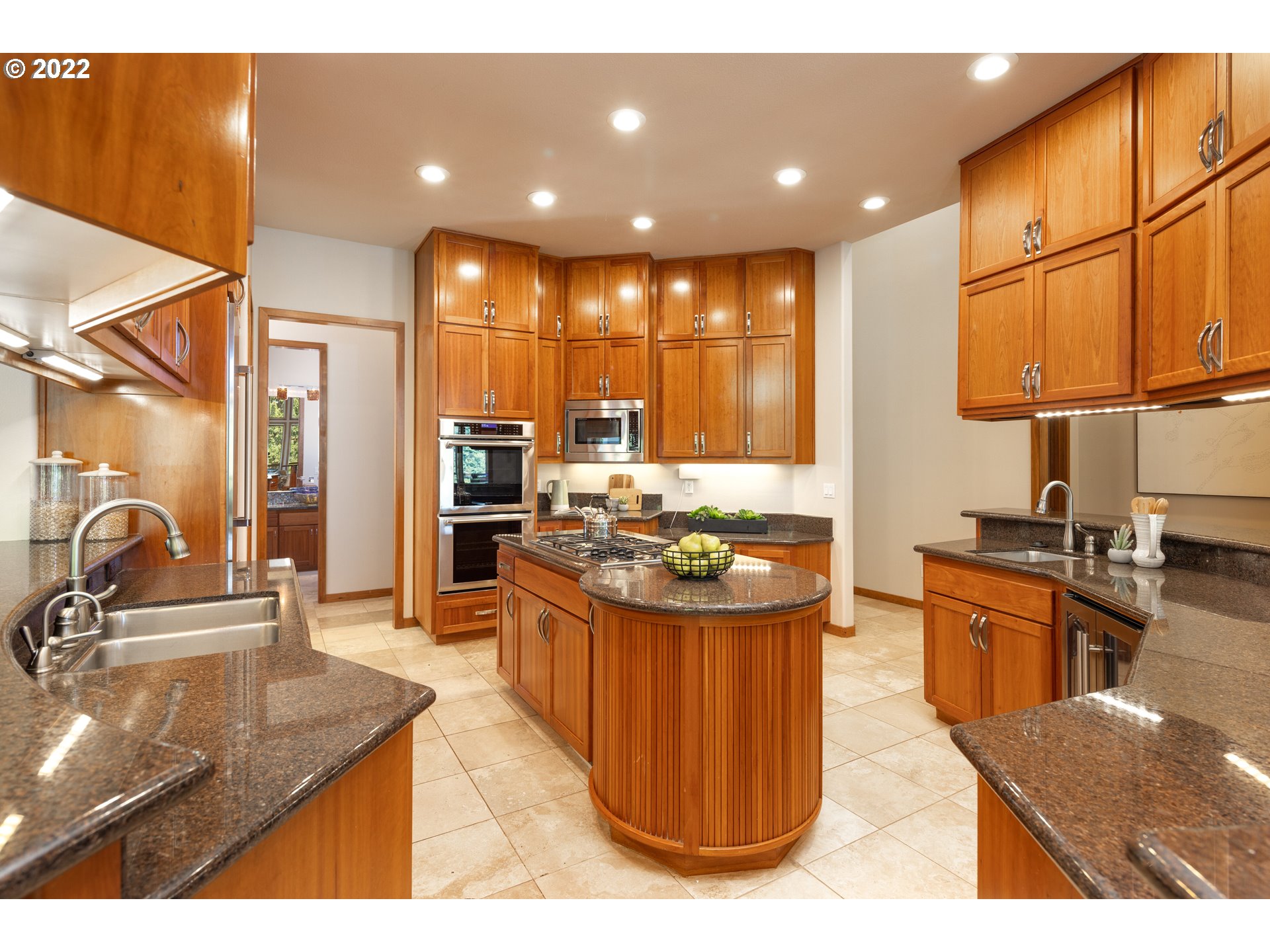 6228 Northwest El Rey Drive Camas, WA 98607 - Photo 12 of 32 a kitchen with stainless steel appliances kitchen island granite countertop a sink and cabinets