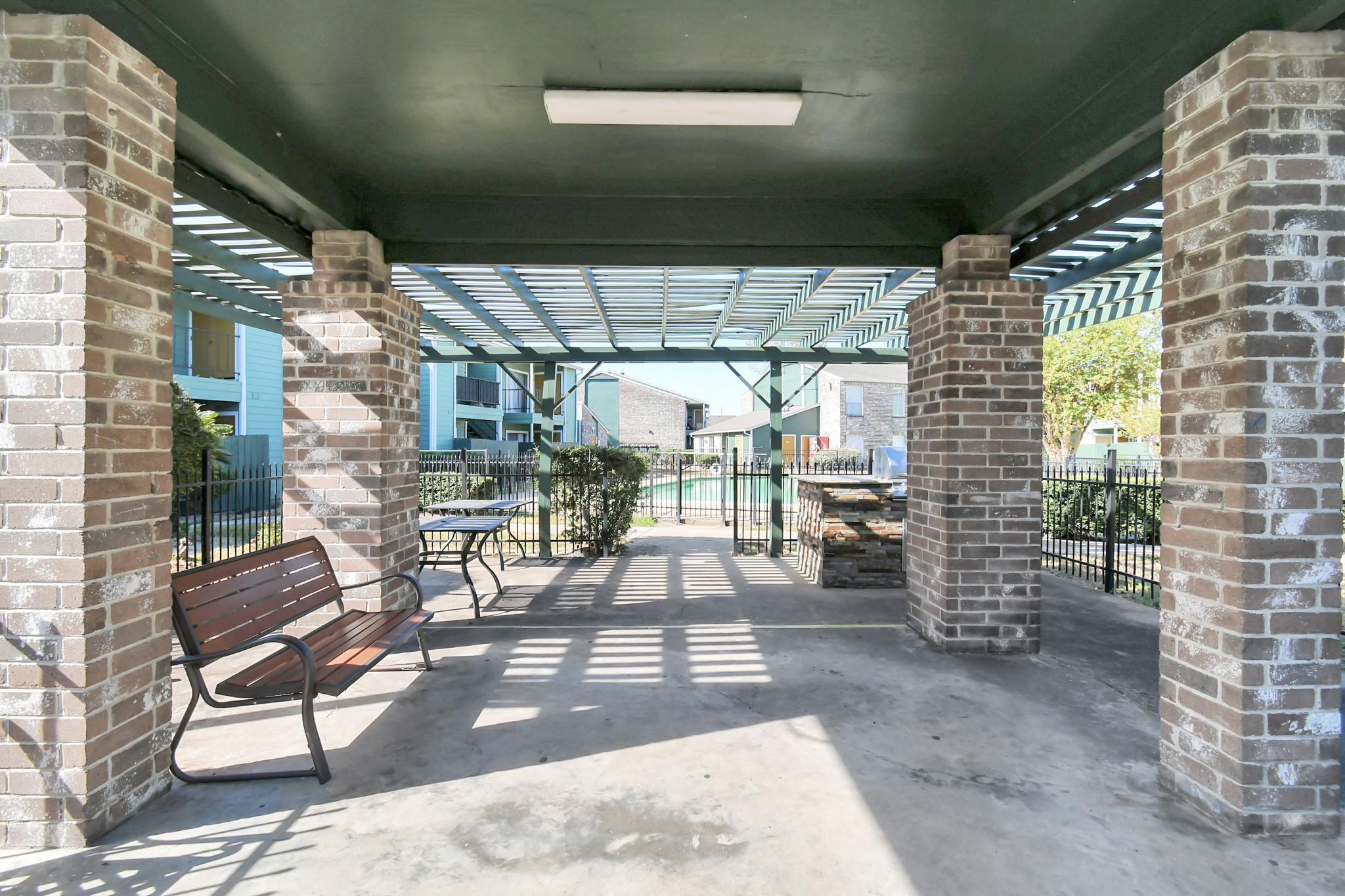 a view of a porch with chairs and floor to ceiling window
