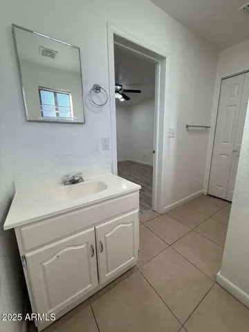a bathroom with a sink a toilet and mirror