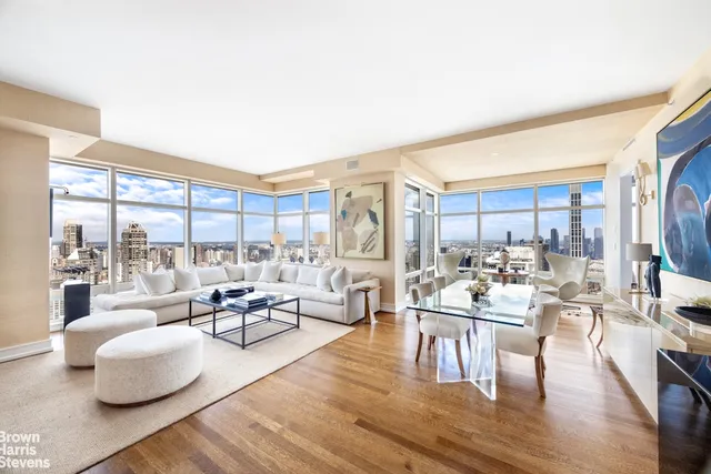 a living room with fireplace furniture and a large window