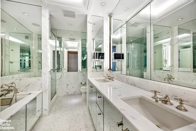 a spacious bedroom with a bed and a large window