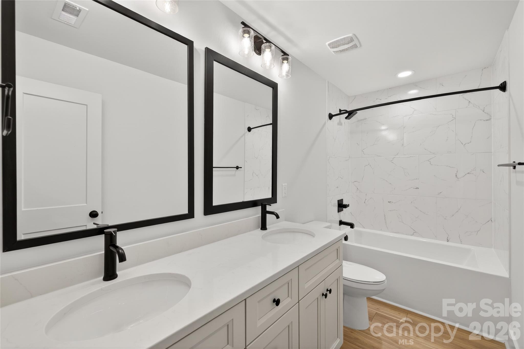 3388 Brackhill Street Davidson, NC 28036 - Photo 13 of 17 a bathroom with a sink and a mirror with toilet