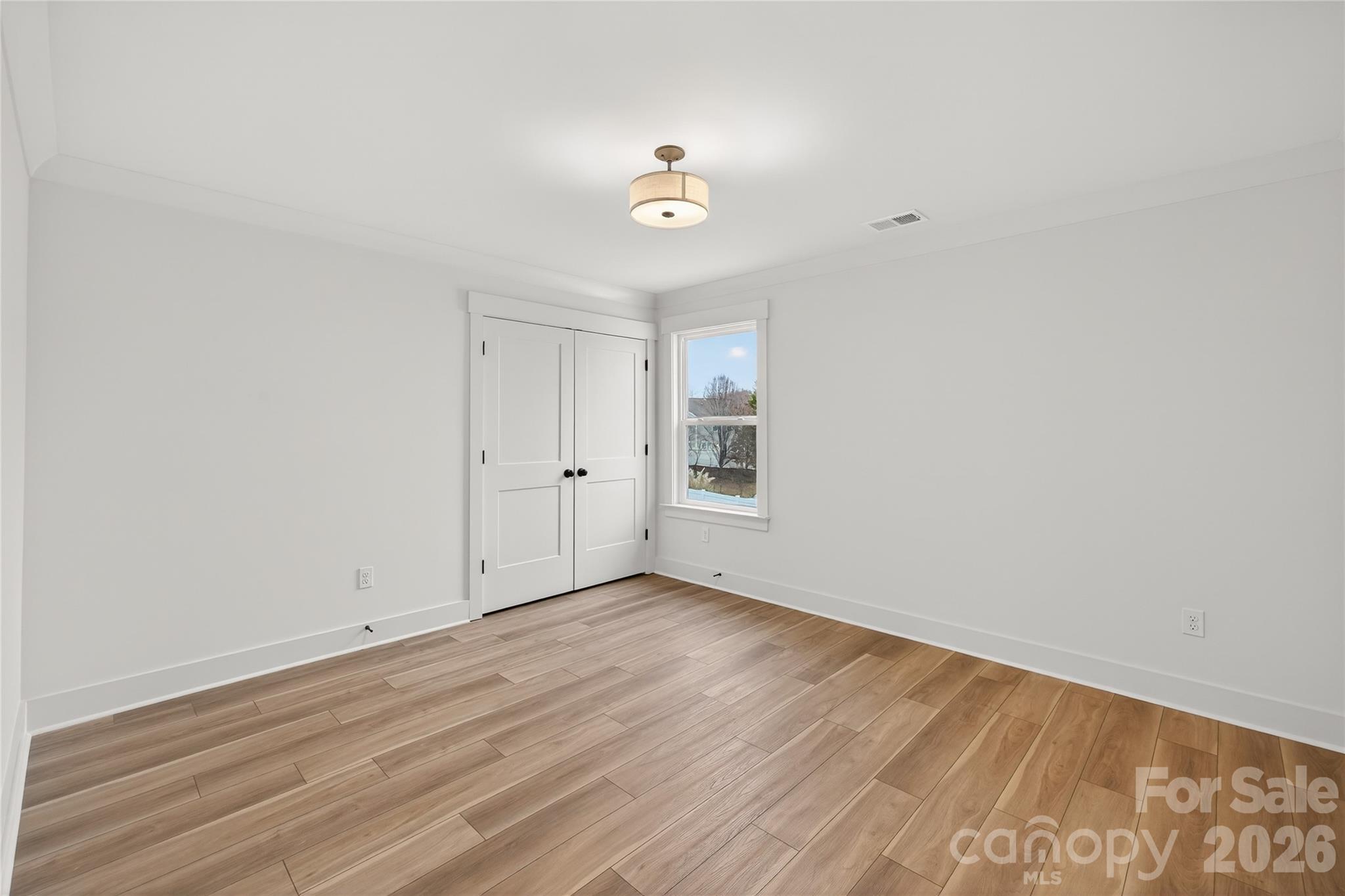 3388 Brackhill Street Davidson, NC 28036 - Photo 15 of 17 wooden floor in an empty room with a window