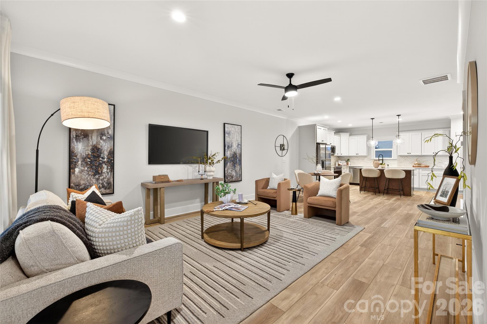 3388 Brackhill Street Davidson, NC 28036 - Photo 2 of 17 a living room with furniture a flat screen tv and a view of kitchen