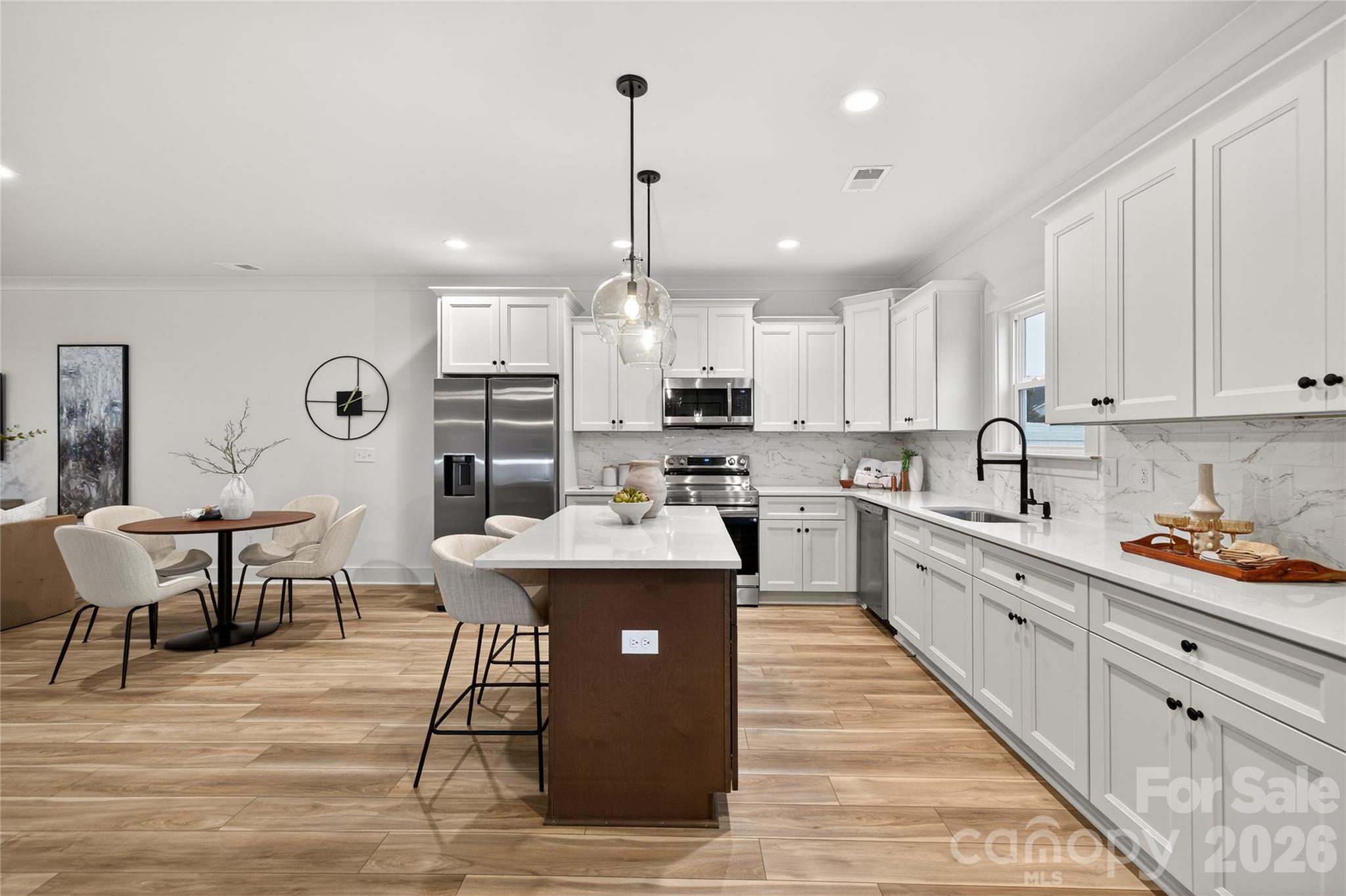 3388 Brackhill Street Davidson, NC 28036 - Photo 6 of 17 a large kitchen with kitchen island a island a sink a stove and a center island