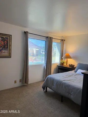 a bedroom with a bed and window