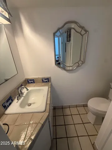 a bathroom with a sink toilet and mirror
