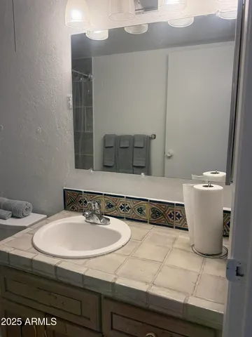 a bathroom with a sink and a mirror