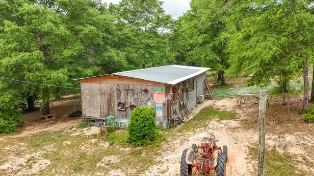 a view of a swimming pool with a table and chairs under an umbrella
