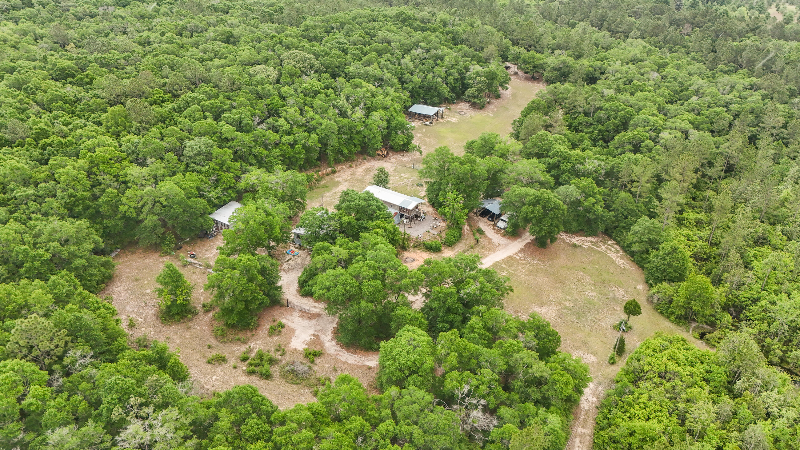 841 North 1st Street DeFuniak Springs, FL 32433 - Photo 25 of 63 an aerial view of residential house with outdoor space and trees all around