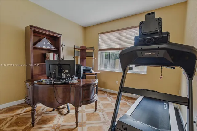 a living room with furniture a flat screen tv and a table