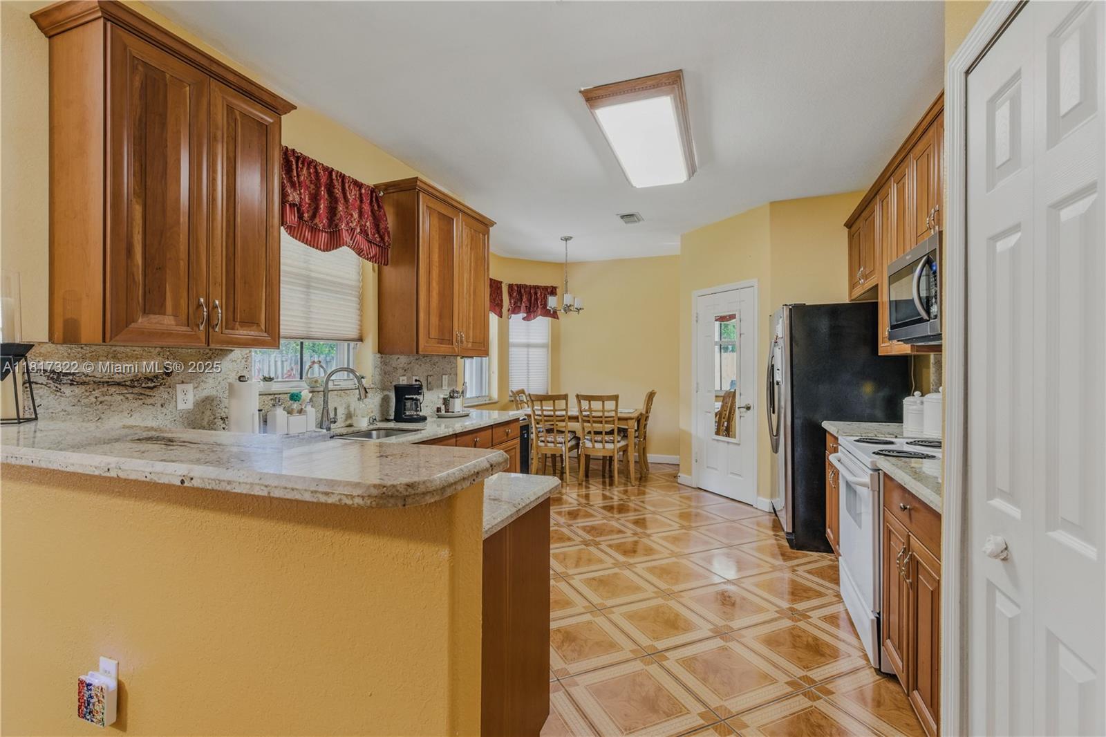 12251 Southwest 122nd Path Miami, FL 33186 - Photo 18 of 56 a kitchen with stainless steel appliances granite countertop a sink and a refrigerator