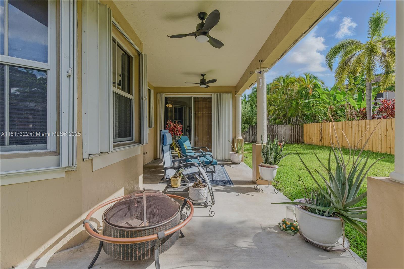 12251 Southwest 122nd Path Miami, FL 33186 - Photo 22 of 56 a view of a patio with table and chairs potted plants with wooden floor