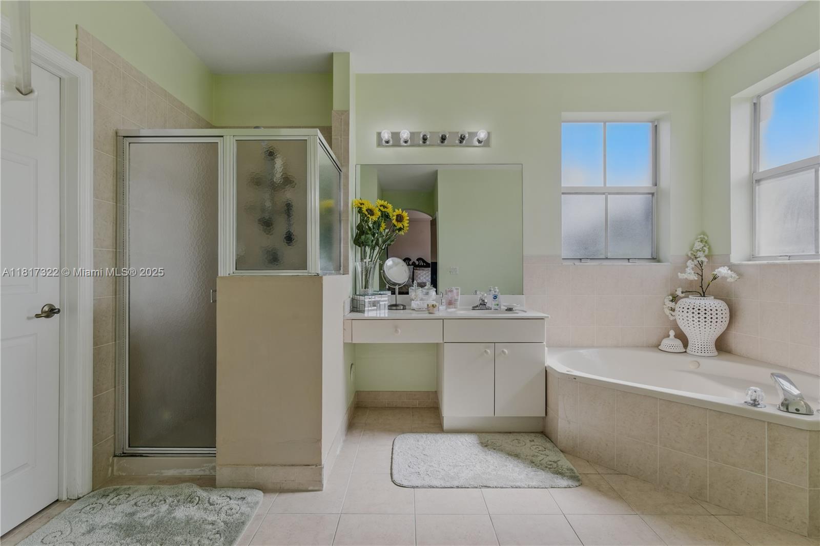 12251 Southwest 122nd Path Miami, FL 33186 - Photo 30 of 56 a bathroom with a tub sink and mirror