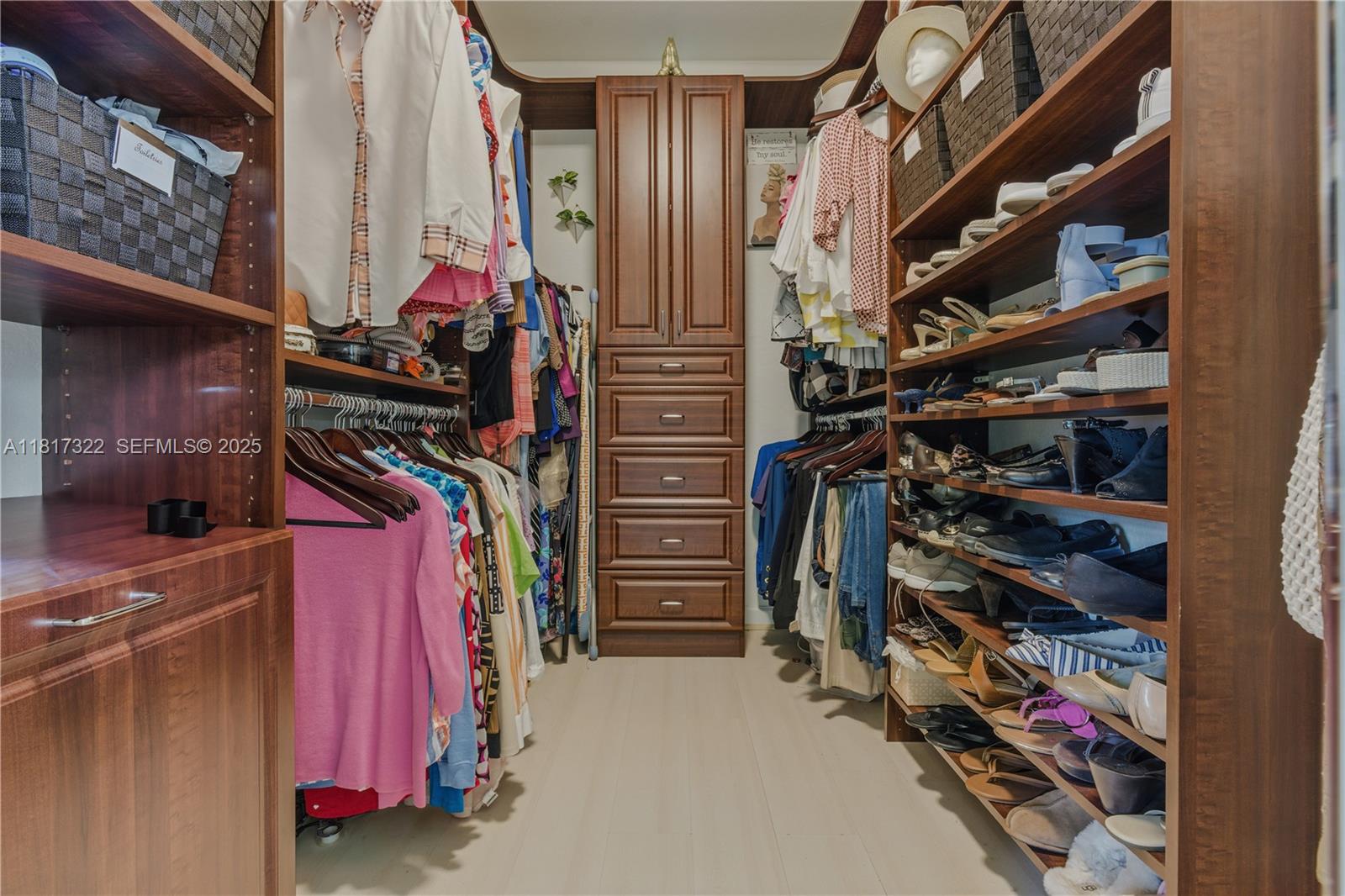 12251 Southwest 122nd Path Miami, FL 33186 - Photo 33 of 56 a view of walk in closet with clothes and shoes