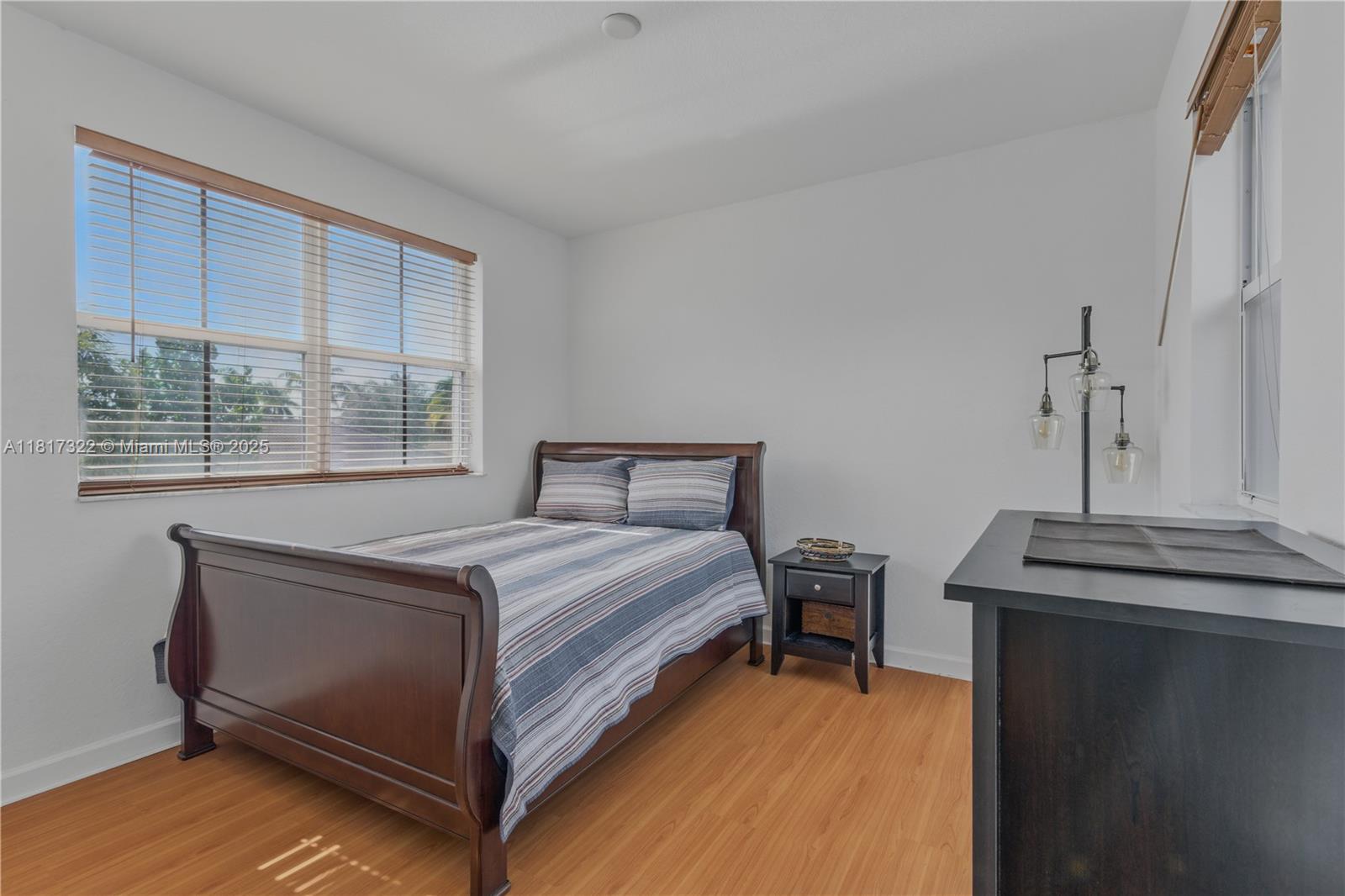 12251 Southwest 122nd Path Miami, FL 33186 - Photo 35 of 56 a bed sitting in a bedroom next to a window